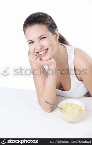 Young girl at breakfast on a white background