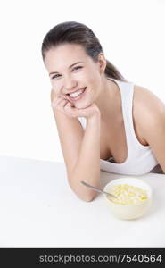 Young girl at breakfast on a white background