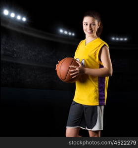 Young girl basketball player at gym