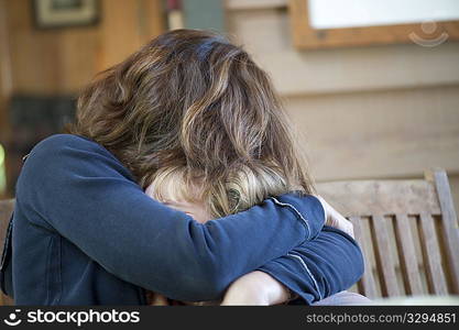 Young girl being hugged by her mother