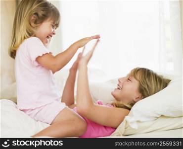 Young Girl Being Woken Up By Her Little Sister