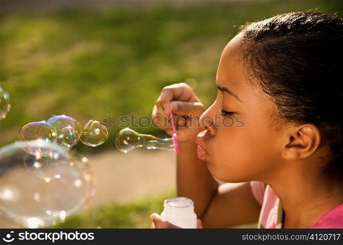 Young Girl Blowing Bubbles
