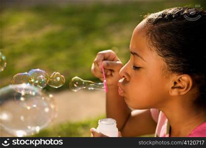 Young Girl Blowing Bubbles
