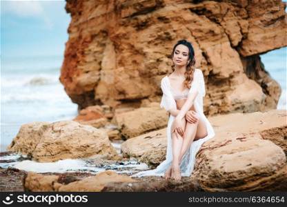young girl bride in her underwear on the shore of the sea dreams of the future