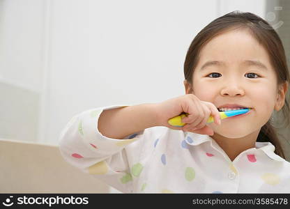 Young Girl Brushing Her Teeth