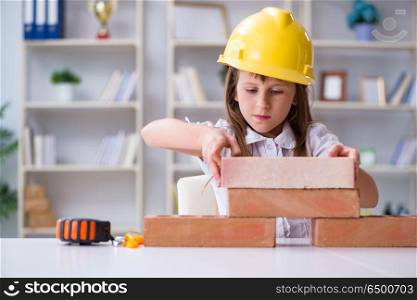 Young girl building with construction bricks