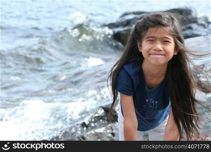 Young girl by a lakes edge