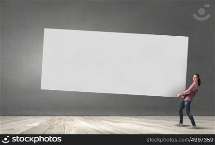 Young girl carrying white blank banner place for text. Banner for advertisement