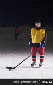 young girl children ice hockey player portrait on training in black background