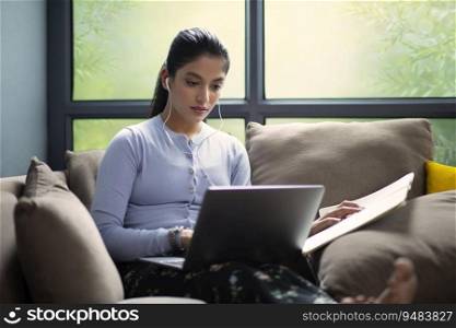 YOUNG GIRL COMFORTABLY SITTING ON SOFA AND ATTENDING ONLINE CLASS