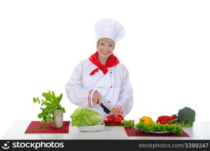 young girl cuts the tomatoes in the kitchen. Isolated on white background