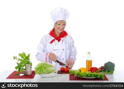 young girl cuts tomatoes. Isolated on white background