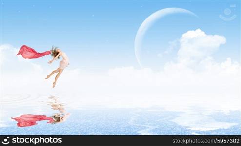 Young girl dancer on water surface