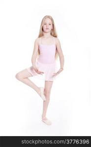 young girl dancing in pink ballet suit in studio with white background