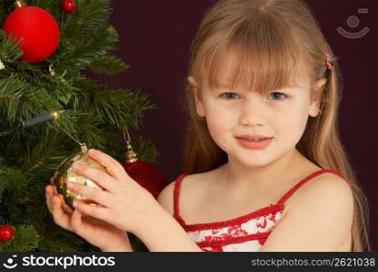 Young Girl Decorating Christmas Tree