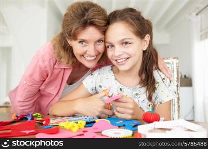 Young girl doing handicrafts with grandmother