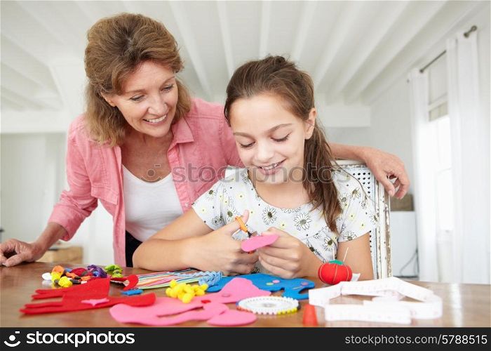 Young girl doing handicrafts with grandmother