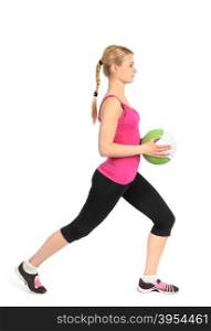 Young girl doing lunges exercise with medicine ball. Young girl doing lunges exercise with medicine ball