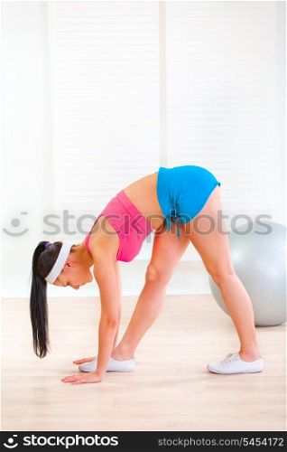 Young girl doing stretching exercises at living room&#xA;