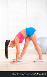 Young girl doing stretching exercises at living room&#xA;