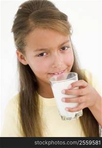 Young girl drinking glass of milk