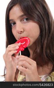 Young girl eating a lollipop