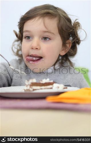 Young girl eating a piece of cake