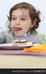 Young girl eating a piece of cake