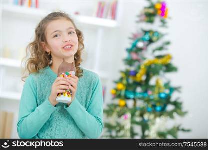 Young girl eating Christmas chocolate