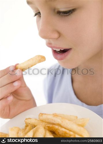 Young girl eating French fries