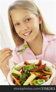 Young Girl Eating Fresh Salad