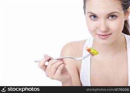 Young girl eating salad isolated