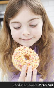 Young Girl Eating Sugary Donut For Snack