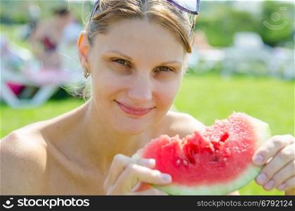 Young girl eating watermelon, close up portrait