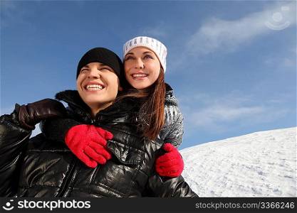 young girl embracing man from back, smiling and looking left, winter day