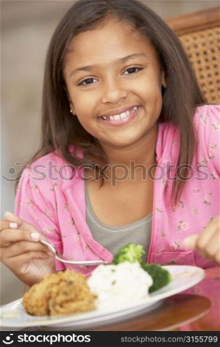 Young Girl Enjoying A Meal At Home