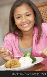 Young Girl Enjoying A Meal At Home