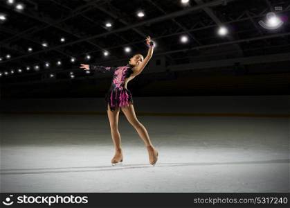 Young girl figure skater in sports hall