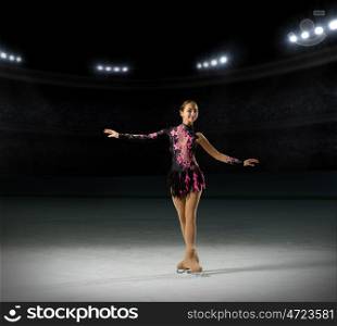 Young girl figure skater (on ice arena with spotlights ver)