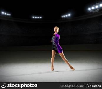 Young girl figure skater (on ice arena with spotlights version)
