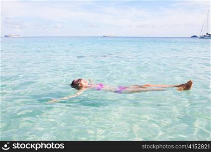 Young Girl Floating In Andaman Sea, Thailand.