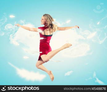 Young girl floating. Young girl flying among the feathers like a bird