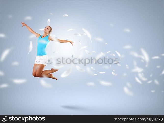 Young girl floating. Young girl flying among the feathers like a bird
