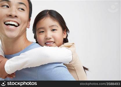 Young Girl Getting a Piggyback Ride with Father