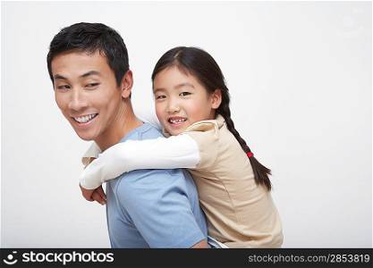 Young Girl Getting Piggyback Ride with Father