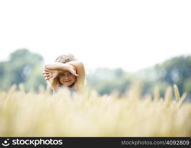 Young girl hiding in corn field