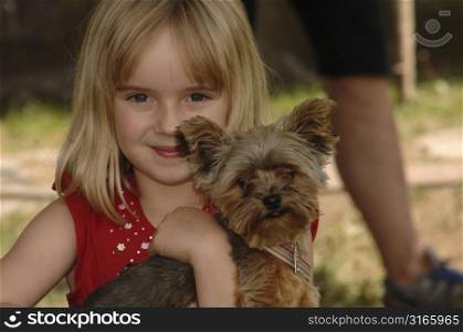 Young girl holding a dog
