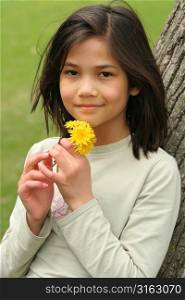 Young girl holding a flower