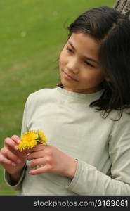 Young girl holding a flower