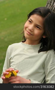 Young girl holding a flower